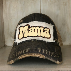 A distressed, vintage black baseball hat with an oversized white 'Mama' logo on the front.