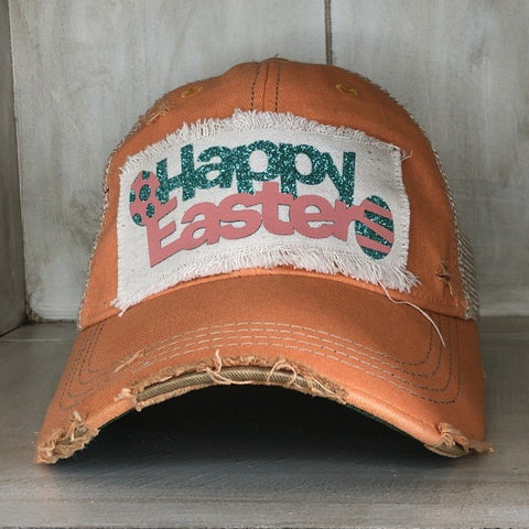 A vintage orange sherbet baseball cap with a 'Happy Easter' text and a large green egg graphic on the front.