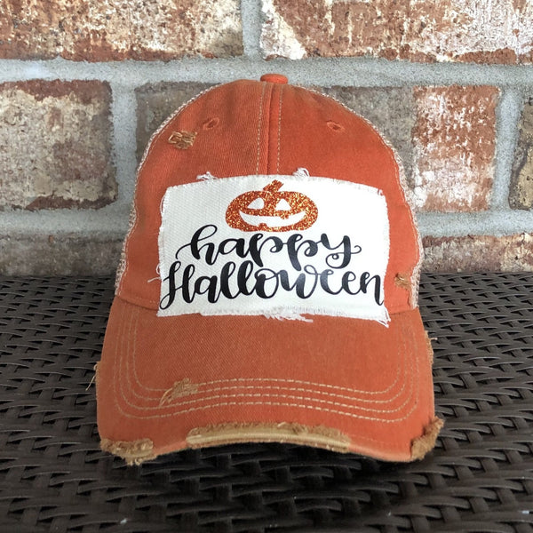 A vintage orange baseball cap with 'Happy Halloween' text and a pumpkin design on the front.