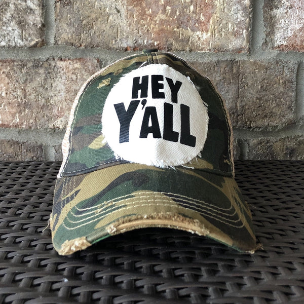 A distressed, vintage feel baseball hat with 'Hey Y'All' text on the front.