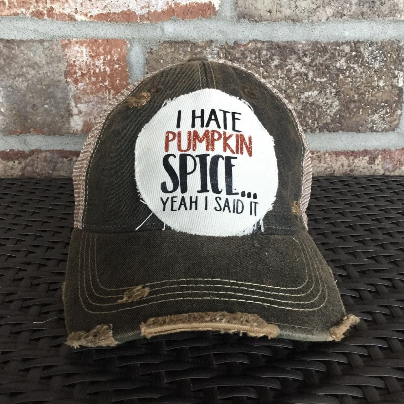 A distressed, vintage feel baseball hat with 'I Hate Pumpkin Spice' text on the front.