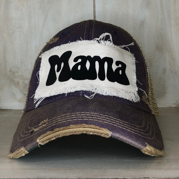 A purple distressed baseball cap with an oversized white 'MAMA' text logo on the front.